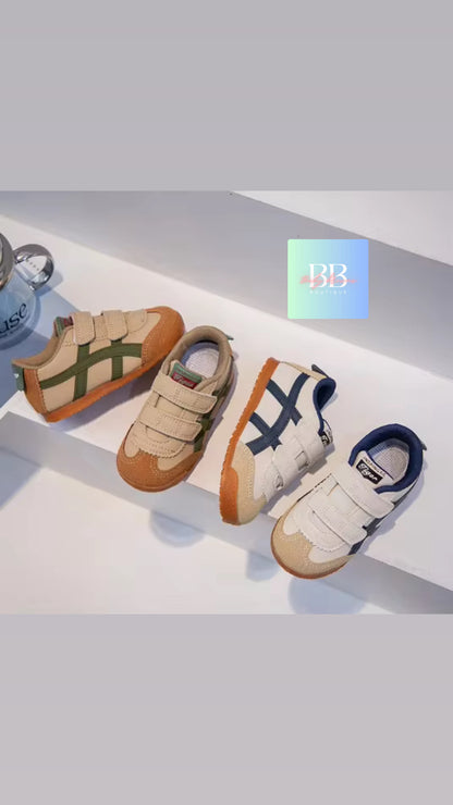 Two pairs of children's shoes on a white surface with a blue 'BB' logo in the corner.