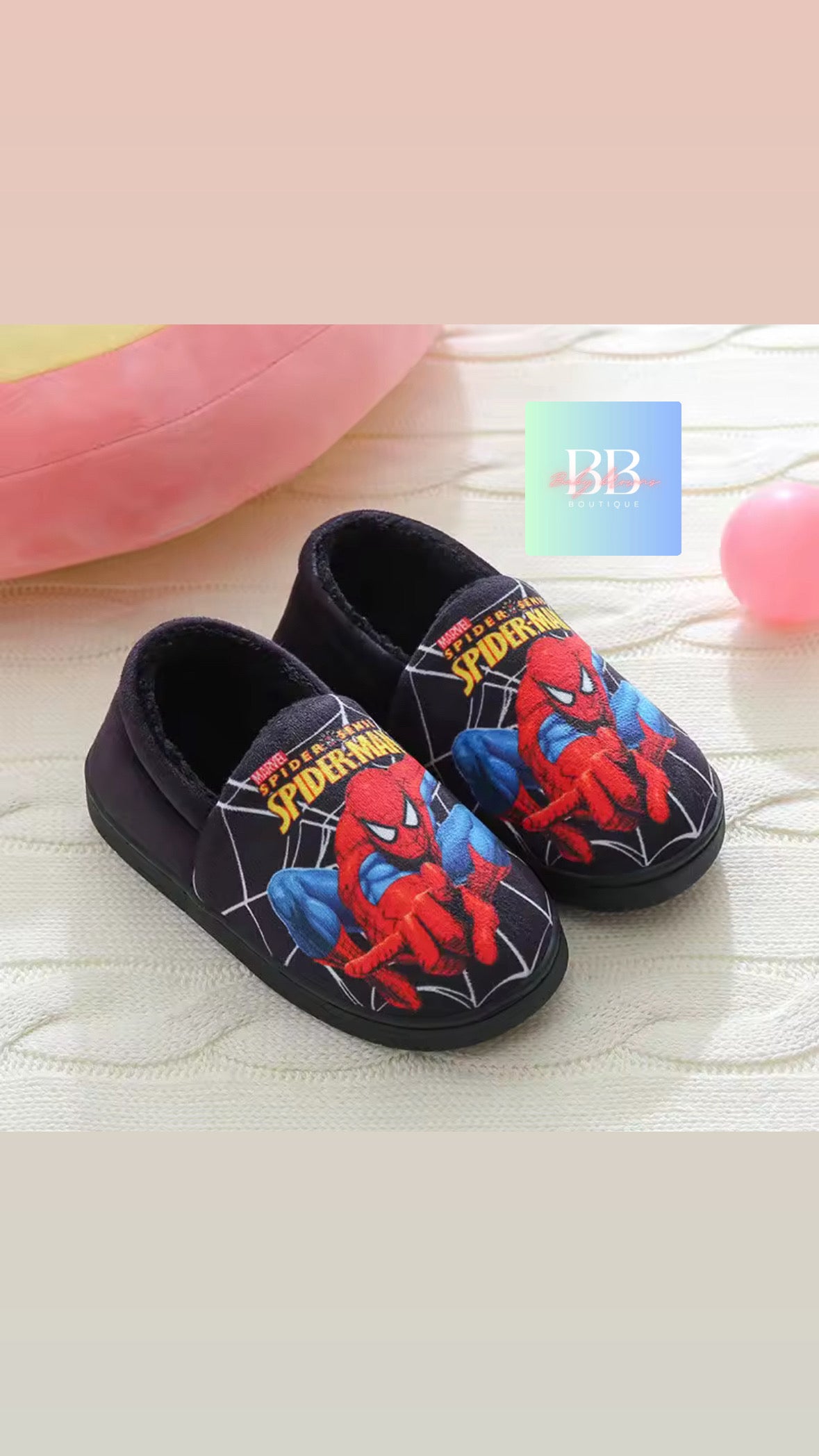 Spider-Man themed children's shoes on a soft surface