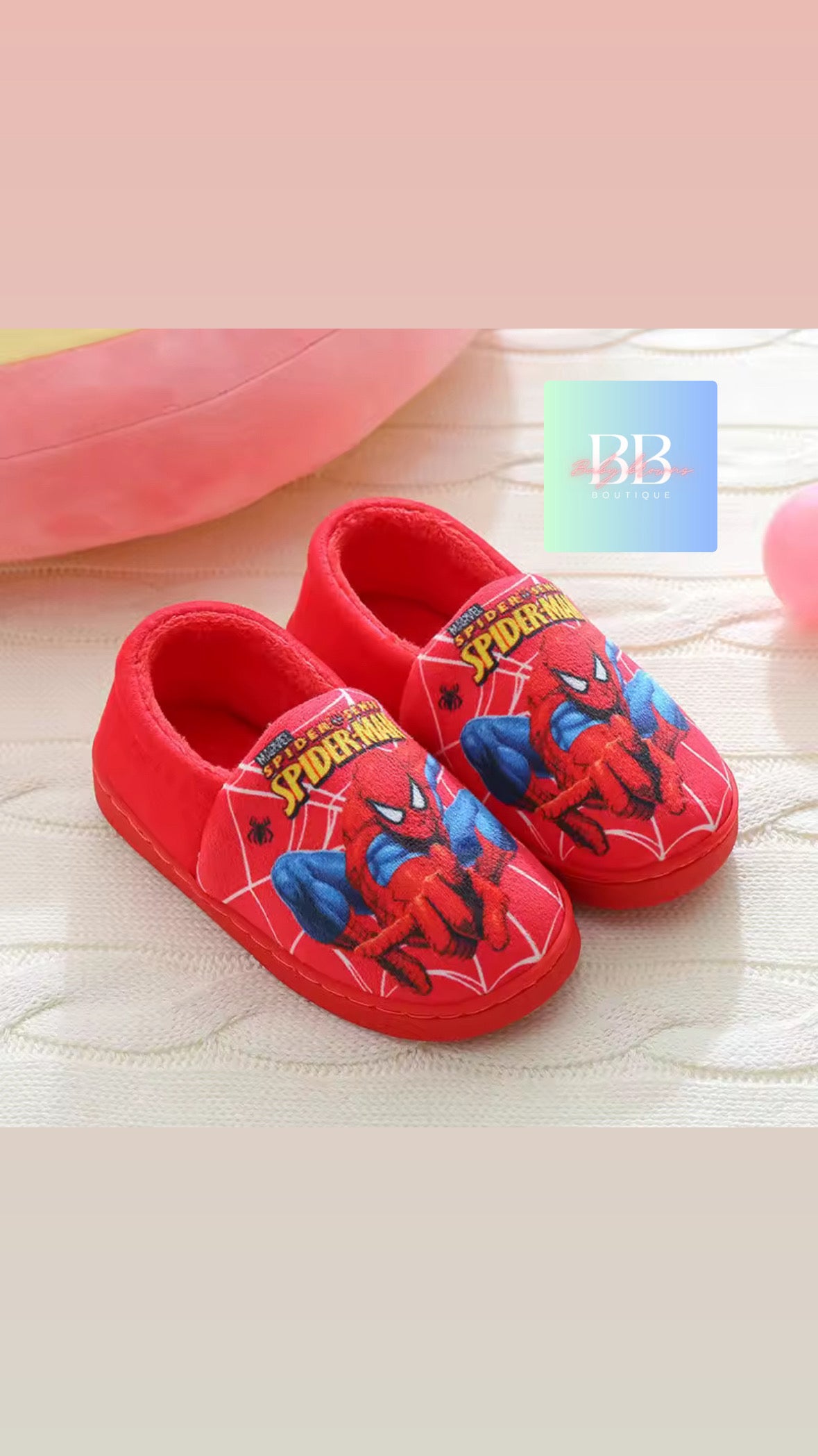 Red children's shoes with Spider-Man design on a light background