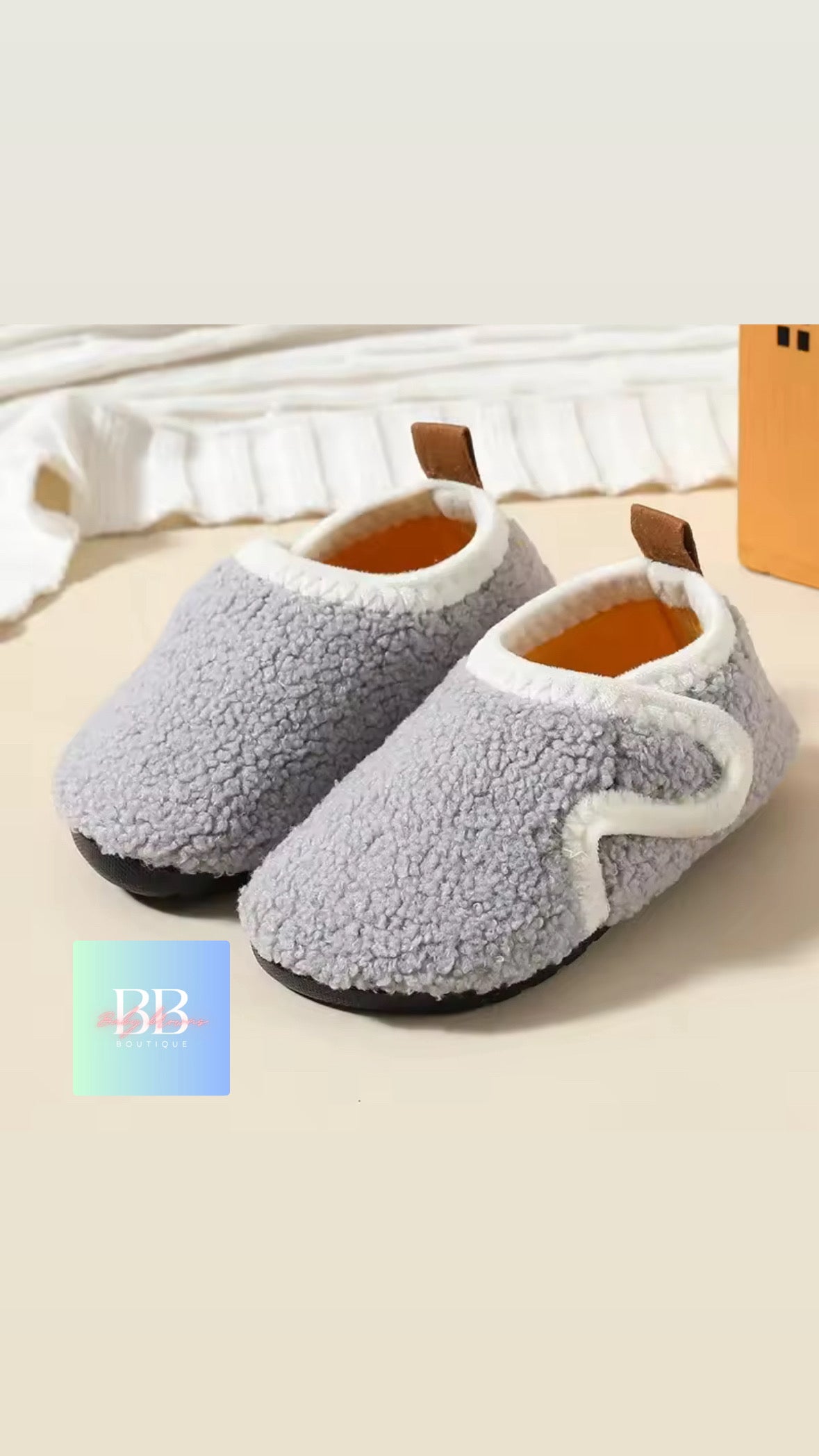Gray slippers with white accents on a light background