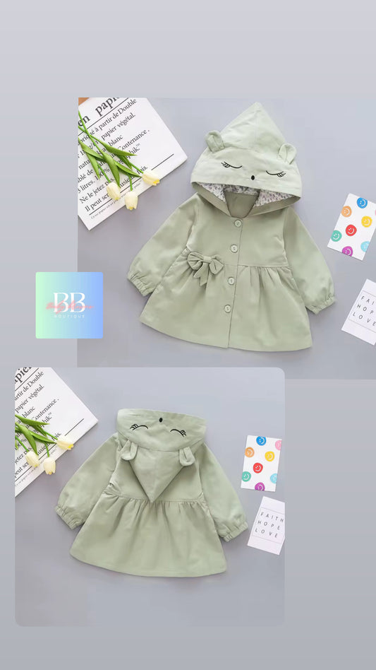 Green children's coat with hood on a light gray background