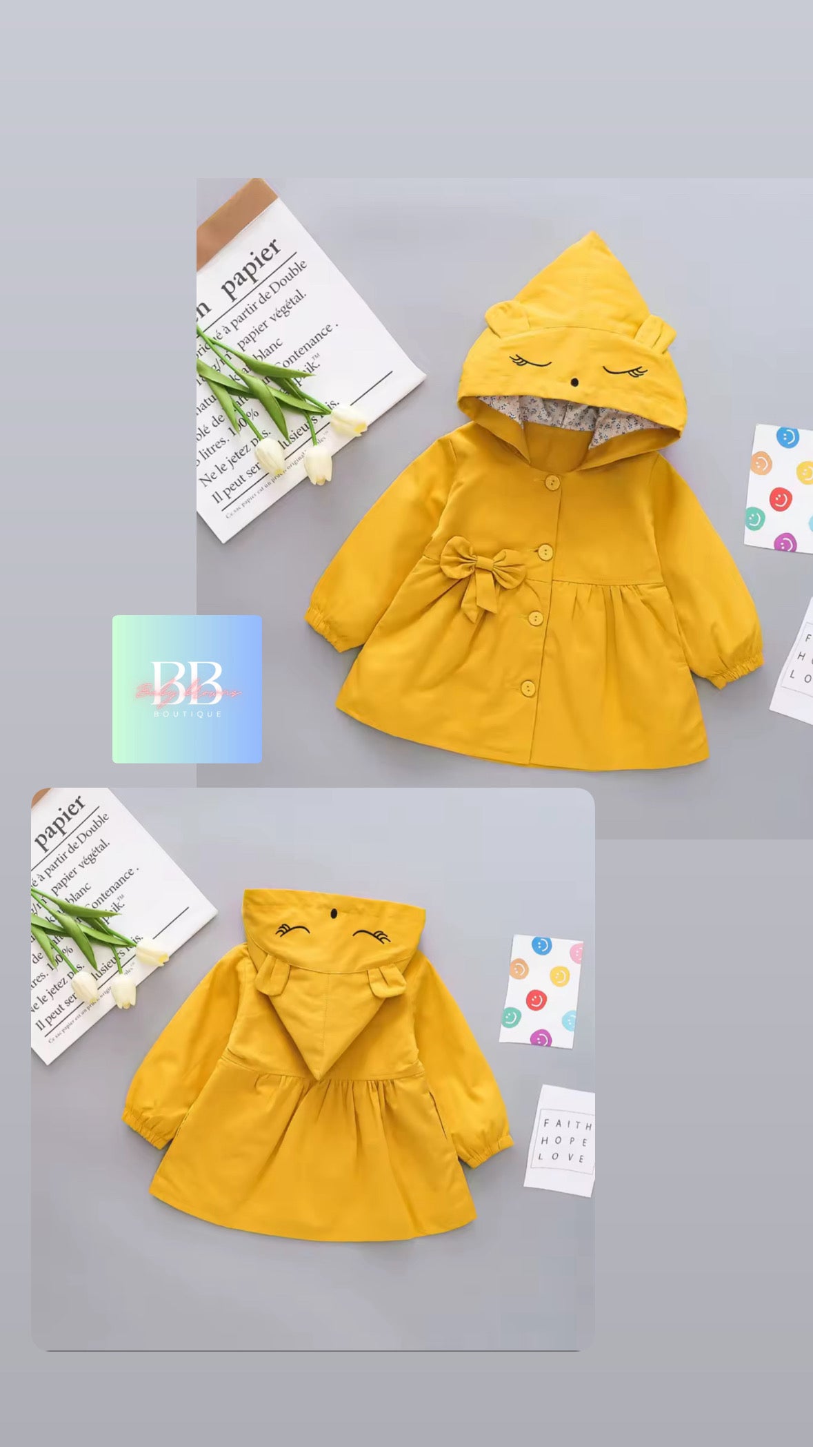 Yellow children's raincoat with a hood on a gray background