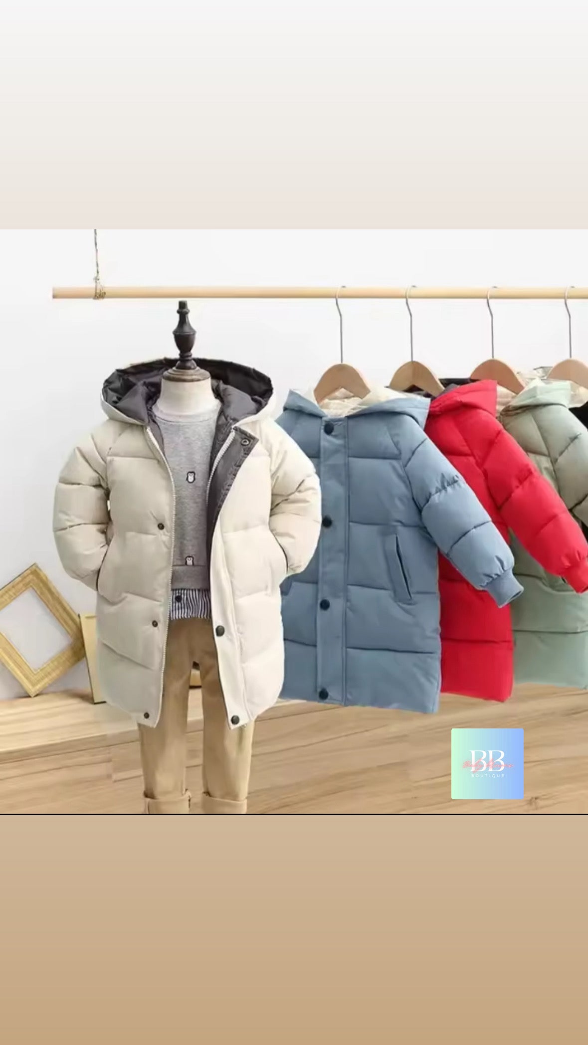 Row of colorful winter jackets on hangers against a white background