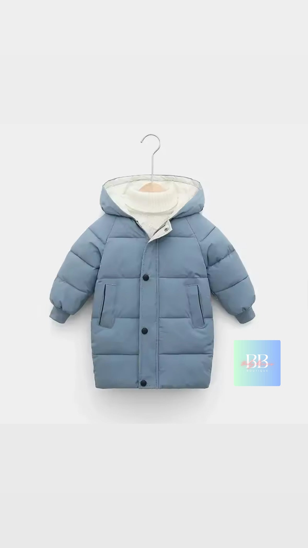 Blue children's puffer jacket on a hanger against a light gray background