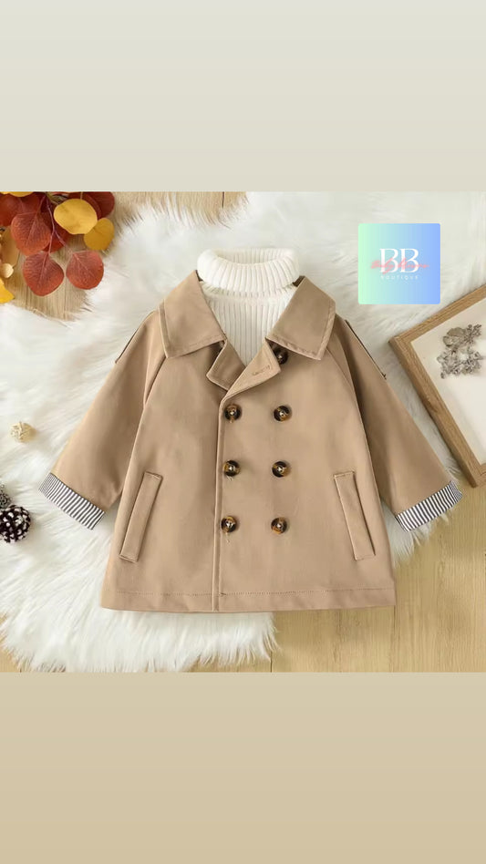 Beige coat on a white fur surface with decorative elements