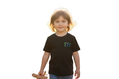 Child wearing a black t-shirt with a butterfly logo in a park setting