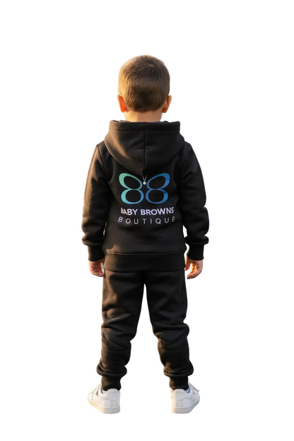 Child wearing a black hoodie with a logo and text, standing against a white background