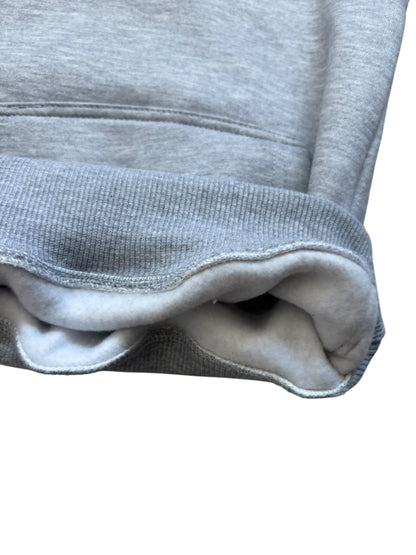 Close-up of a gray sweatshirt with a white background